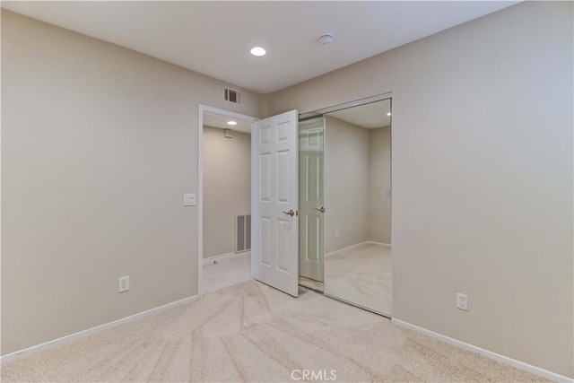 unfurnished bedroom with visible vents, carpet floors, baseboards, a closet, and recessed lighting