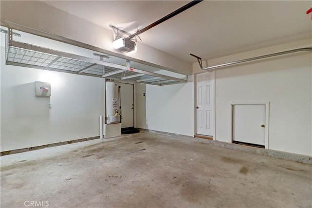 garage with a garage door opener and water heater