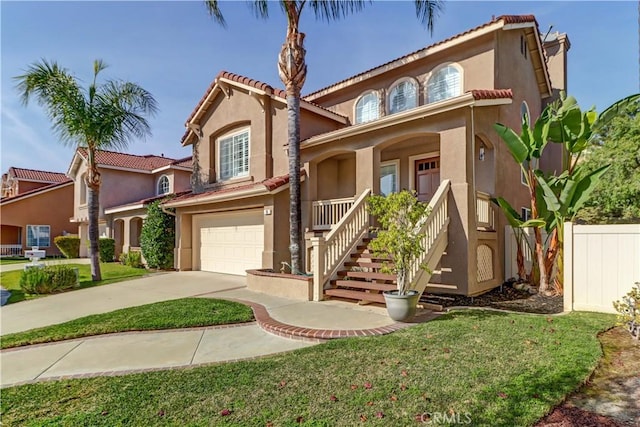 mediterranean / spanish house featuring a garage, covered porch, stucco siding, concrete driveway, and a tile roof