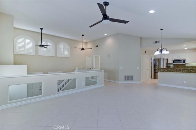 unfurnished living room with visible vents, ceiling fan with notable chandelier, recessed lighting, and lofted ceiling