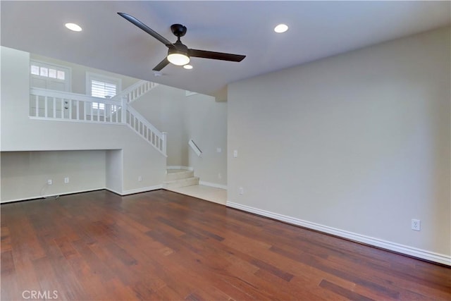 unfurnished living room featuring dark wood-style flooring, recessed lighting, ceiling fan, baseboards, and stairs