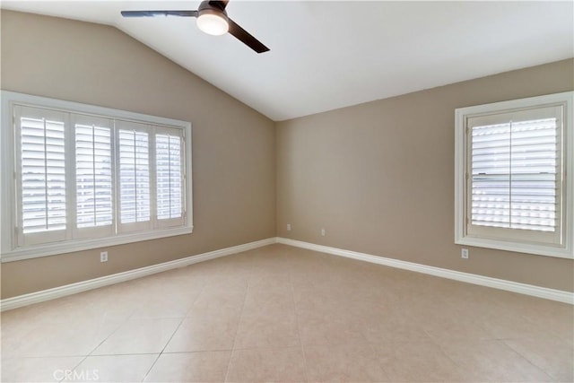 empty room with ceiling fan, baseboards, vaulted ceiling, and light tile patterned flooring