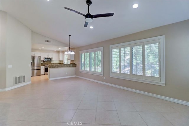 unfurnished living room with visible vents, a ceiling fan, light tile patterned flooring, and vaulted ceiling