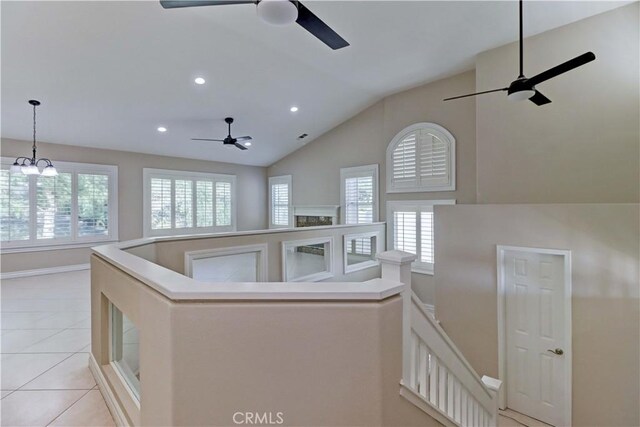 interior space with a ceiling fan, a wealth of natural light, and lofted ceiling
