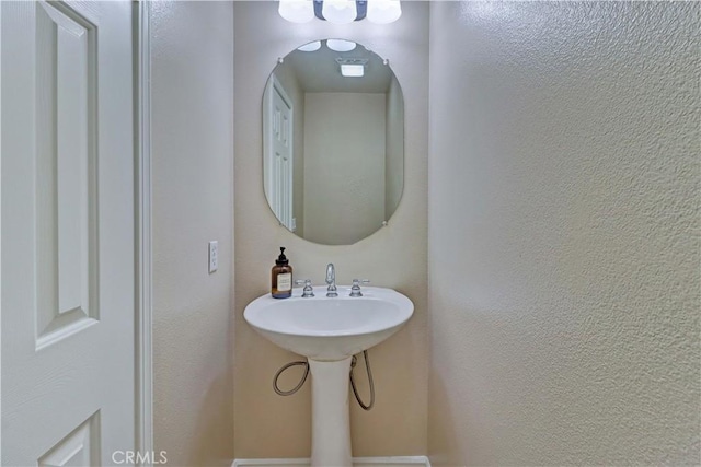 bathroom with a textured wall