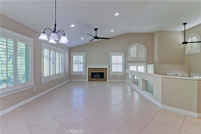 unfurnished living room with light tile patterned floors, a fireplace, and ceiling fan with notable chandelier