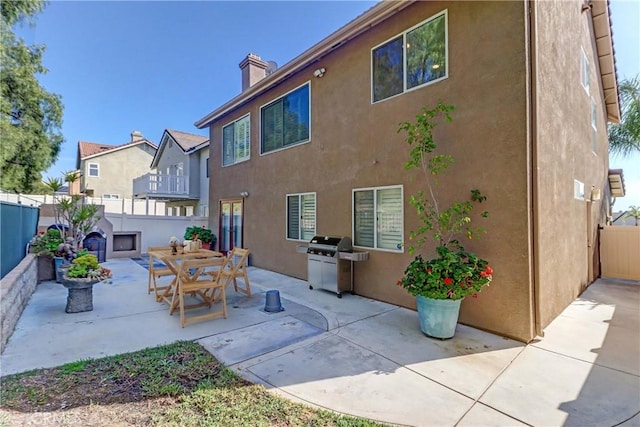 15 Embassy Pl, Lake Forest, CA 92610 - back of property with stucco siding, a fenced backyard, a patio, and a chimney