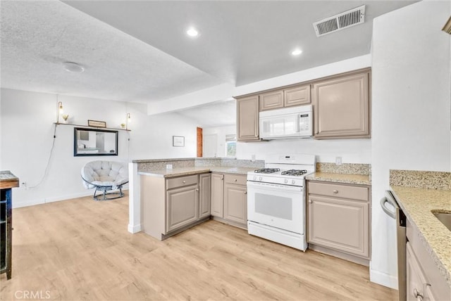 kitchen featuring lofted ceiling with beams, white appliances, light stone counters, and light hardwood / wood-style floors