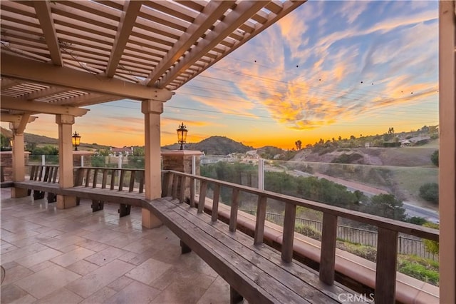 exterior space featuring a mountain view, a pergola, and a patio