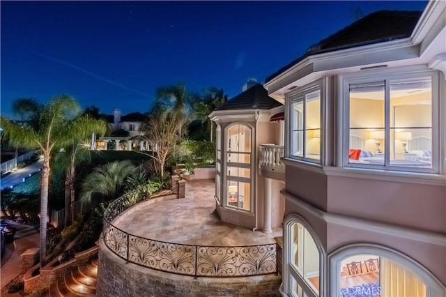 property exterior at twilight with a patio area