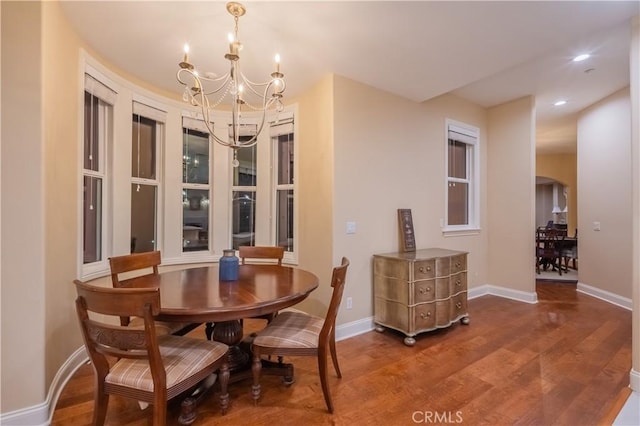 dining room featuring wood-type flooring and a notable chandelier