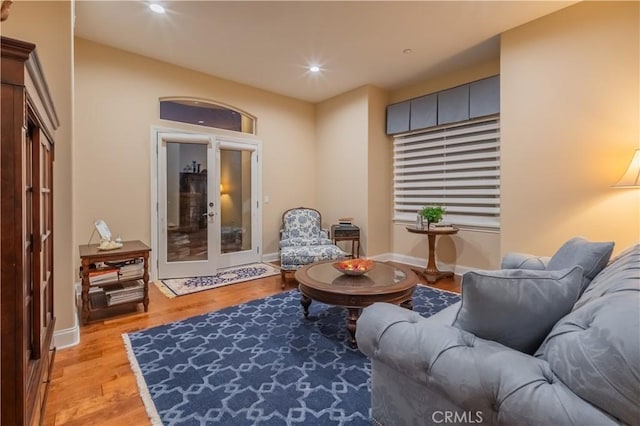 living room with light wood-type flooring and french doors