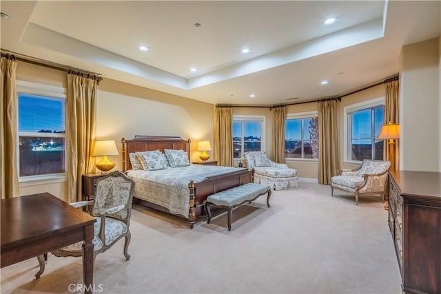 bedroom featuring a tray ceiling and light colored carpet