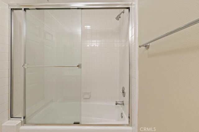 full bathroom featuring bath / shower combo with glass door