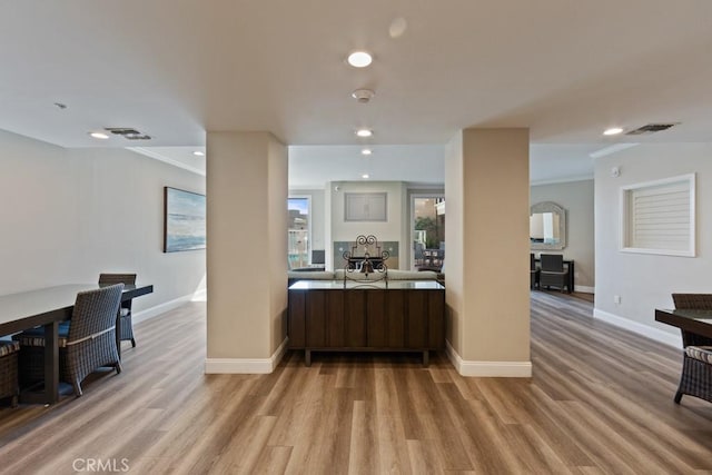 interior space featuring light wood-type flooring, visible vents, and baseboards