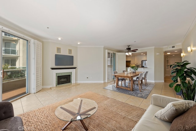 living area with light tile patterned flooring, crown molding, visible vents, and a fireplace