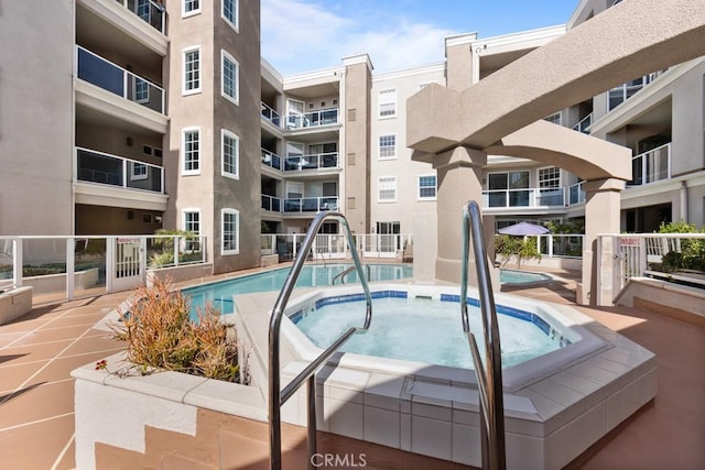 view of swimming pool with a community hot tub