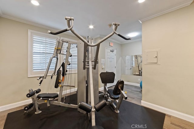 exercise room with ornamental molding, recessed lighting, wood finished floors, and baseboards