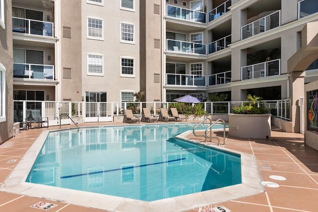 view of pool featuring a patio area and fence