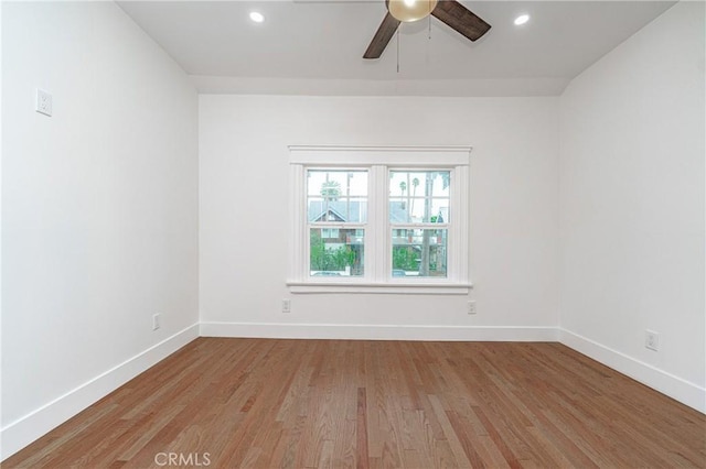 spare room featuring light wood finished floors, ceiling fan, baseboards, and recessed lighting