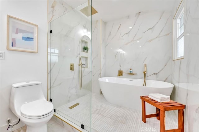 full bathroom with a marble finish shower, a freestanding tub, tile walls, and toilet