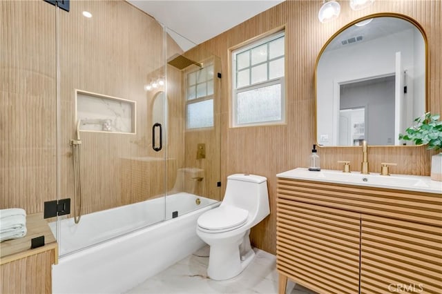 bathroom with marble finish floor, visible vents, toilet, enclosed tub / shower combo, and vanity