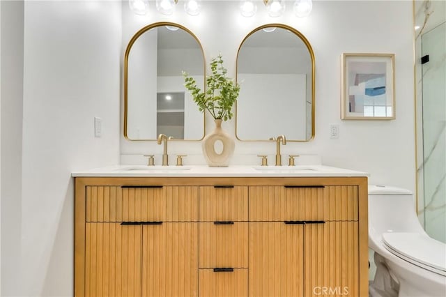 full bathroom featuring a sink, toilet, and double vanity