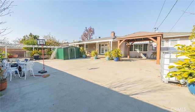 rear view of house with a storage shed, french doors, a patio, a gazebo, and an outdoor structure