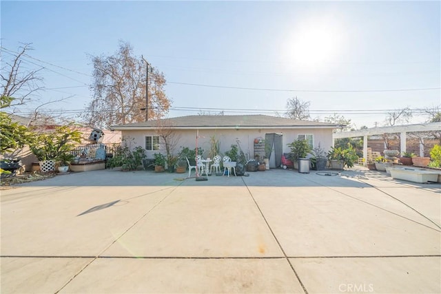 single story home with a patio area, a pergola, and stucco siding