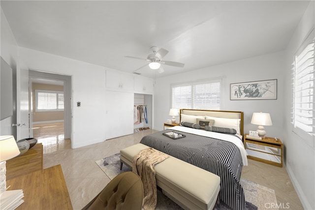 bedroom featuring a closet, ceiling fan, and baseboards