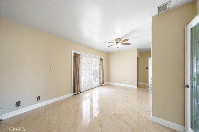 unfurnished room with baseboards, visible vents, and ceiling fan