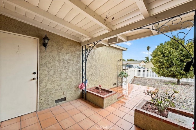 view of patio / terrace featuring fence