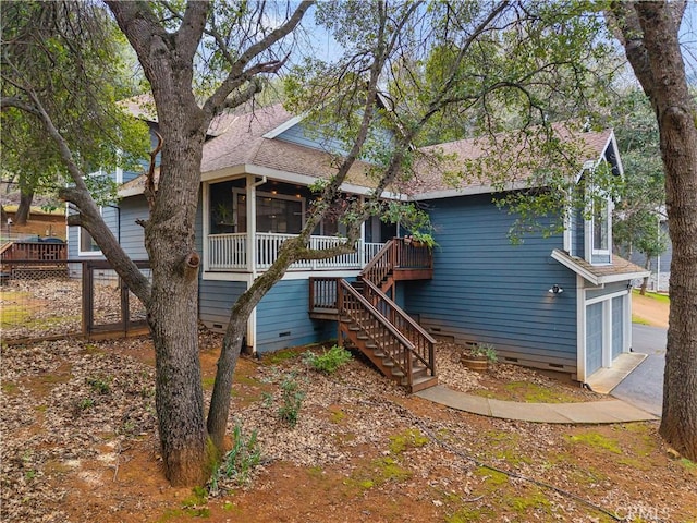 view of front of property with stairway, crawl space, a shingled roof, and a sunroom