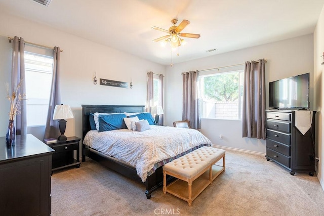 bedroom with ceiling fan and light colored carpet