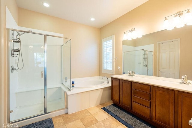 bathroom featuring vanity, tile patterned flooring, and shower with separate bathtub