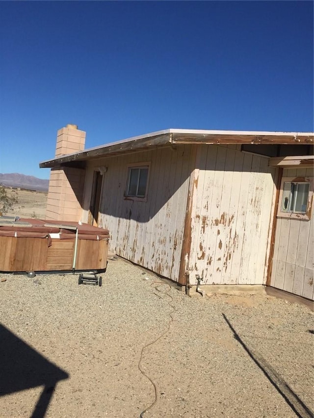 view of property exterior with a hot tub