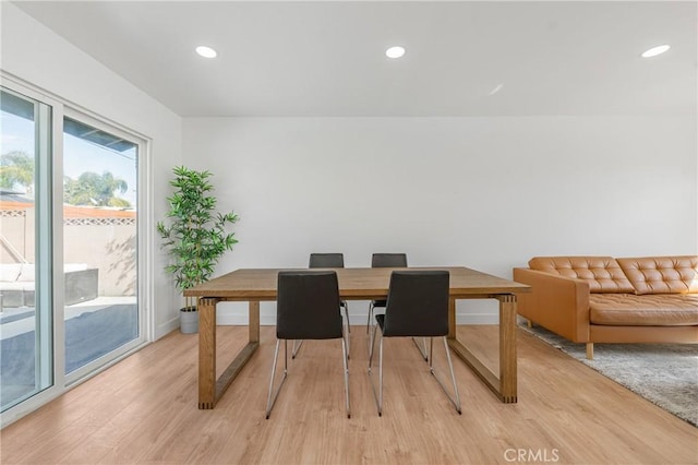 dining space featuring baseboards, light wood-style flooring, and recessed lighting