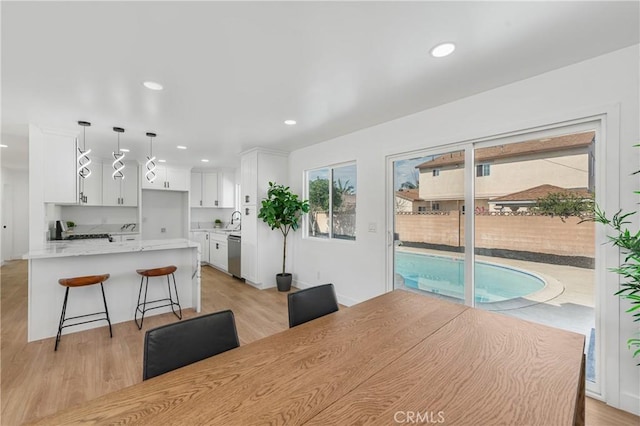 dining area featuring recessed lighting and light wood-style flooring