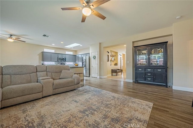 living room with hardwood / wood-style floors and ceiling fan