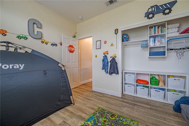 recreation room with hardwood / wood-style floors