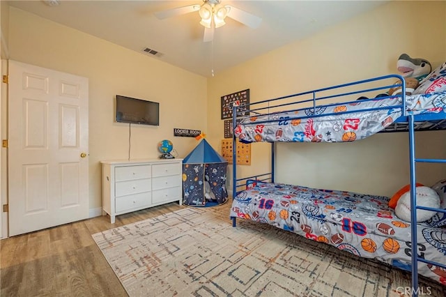 bedroom with ceiling fan and light hardwood / wood-style flooring