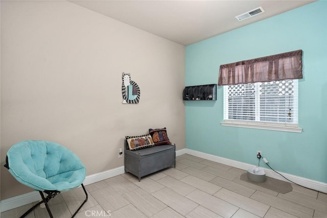 living area with visible vents and baseboards