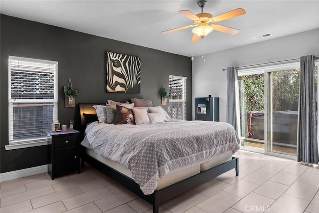 bedroom featuring access to exterior, visible vents, baseboards, and a ceiling fan