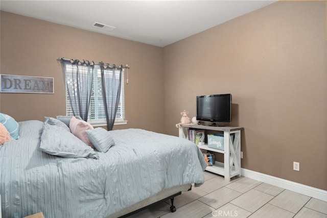 bedroom featuring wood tiled floor, visible vents, and baseboards