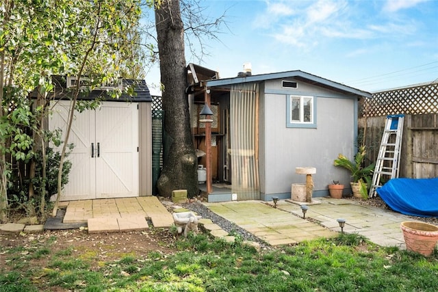 view of shed featuring fence