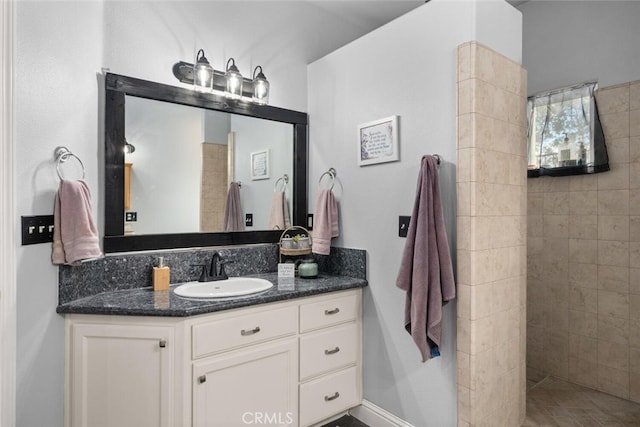 bathroom with walk in shower and vanity