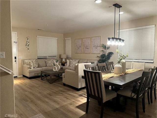 dining space with visible vents and wood finished floors