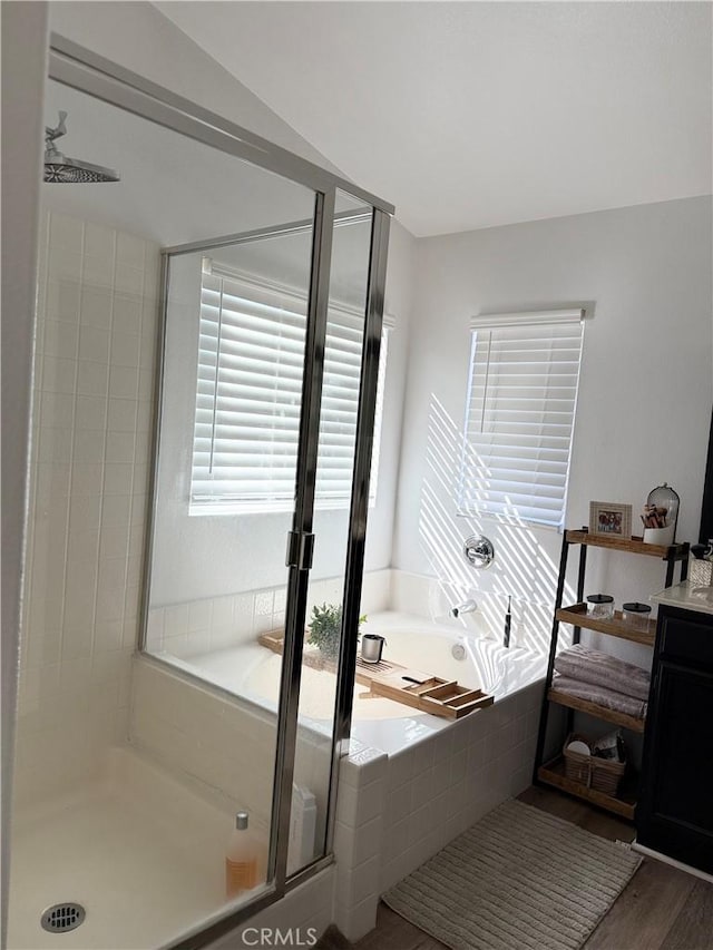 bathroom featuring vanity, wood finished floors, a shower stall, and a bath