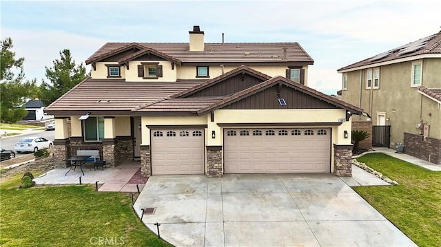 view of front of home with an attached garage, a tile roof, driveway, a chimney, and a front yard