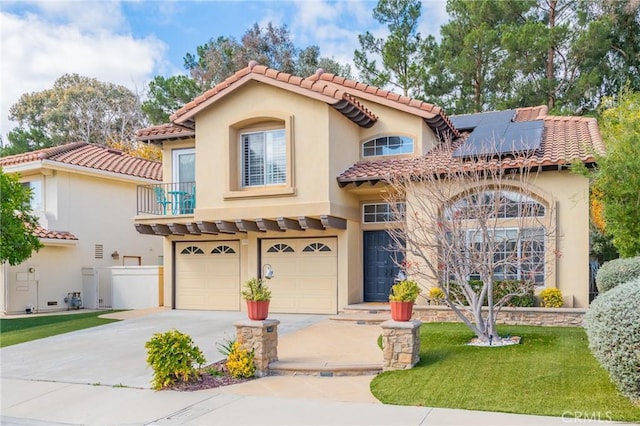 mediterranean / spanish home with a garage, solar panels, a balcony, and a front yard